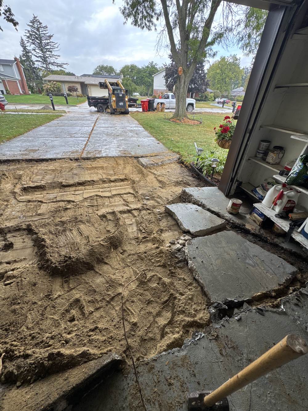 Graded earth base where an old driveway was removed, seen from the garage