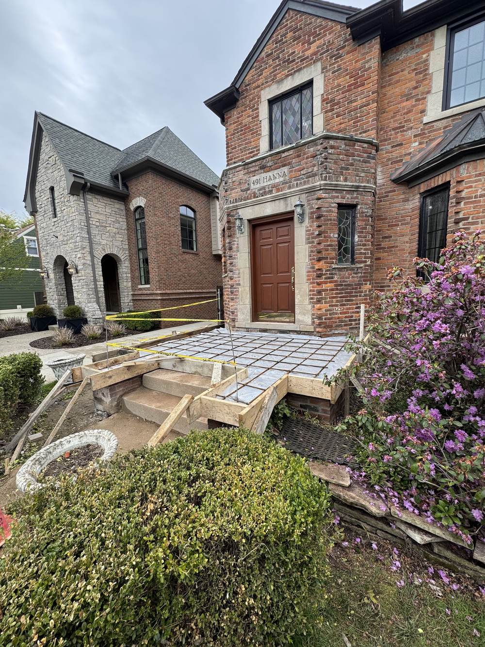 Wood forms and a tied rebar grid on a front porch before the concrete pour